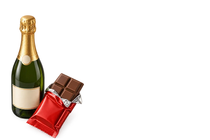 Chocolate bar in foil beside a sparkling wine bottle