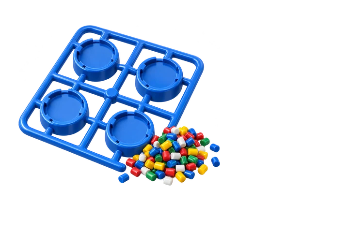 Freshly molded blue caps on a sprue beside coloured plastic pellets